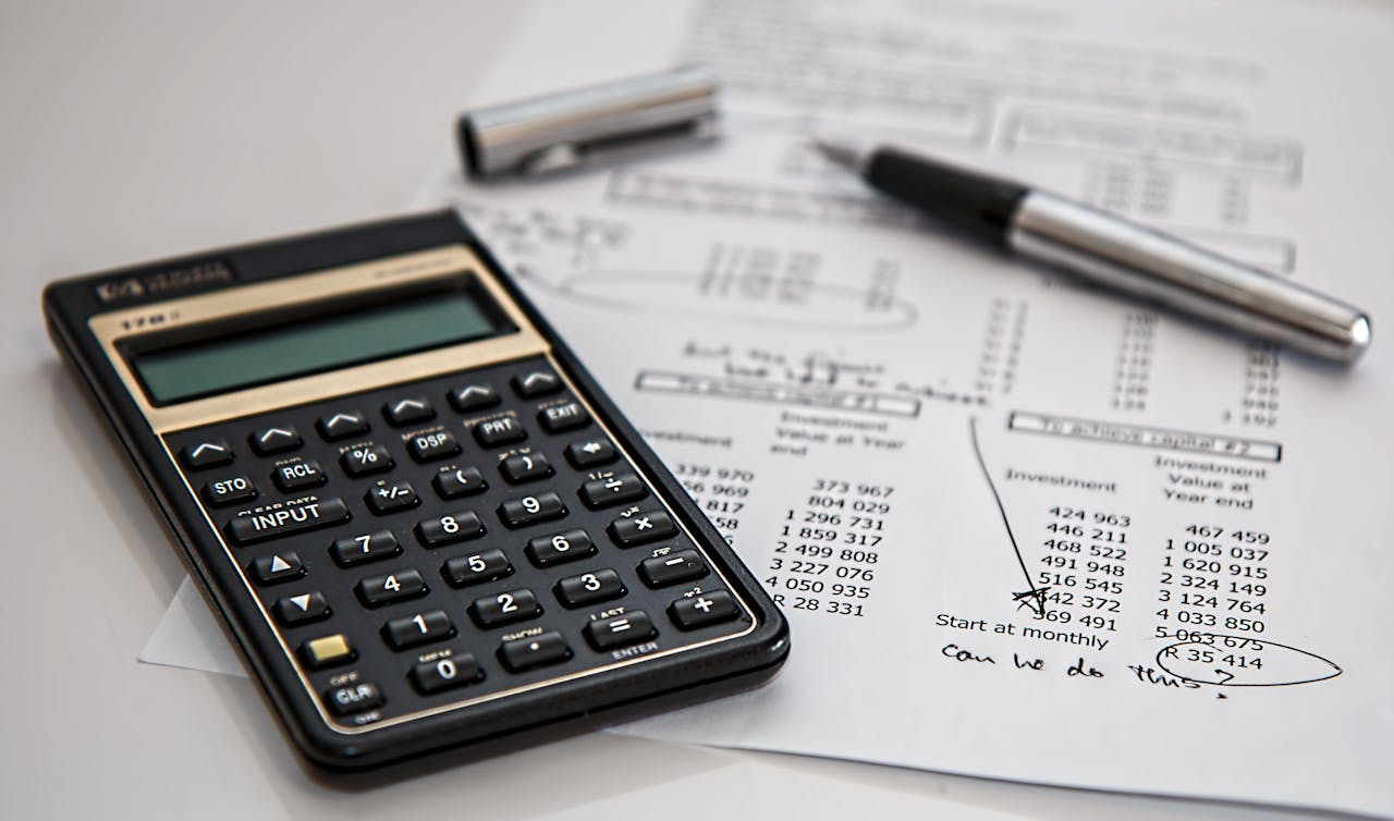 about-img Close-up of financial documents with calculator and pen, ideal for business management themes.